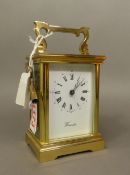 Worcester, late 20th-century heavy brass cased carriage clock, with swing carrying handle,