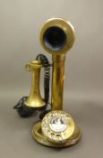 A 20th-century vintage 'Conversation Pieces' brass and bakelite candlestick telephone, height 30cm.