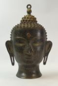 A bronze or brass Southeast Asian style Buddha head with etched designs. (H: 35cm)