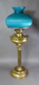 Vintage brass oil lamp in column form with a teal glass shade (no clear glass chimney/flue), overall