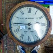 Doncaster Jewellers wall hanging clock with oak frame and pendulum.