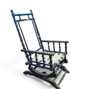 Antique American oak bobbin turned rocking chair with seat webbing visible. H102cm x W54cm x D54cm