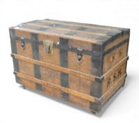 Antique wooden steamer trunk with metal banding and wheels to base, with tray inside. COURIER/