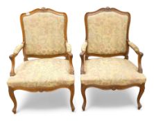 A pair of French carved oak floral tapestry Fauteuils armchairs, with carved decoration and