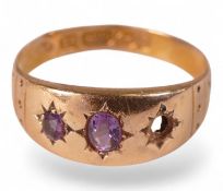 14ct rose gold ring set with three purple stones, size N, 1.6g.
