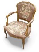 French Louis XV style Oak framed needlepoint armchair, with floral design & carved decoration.