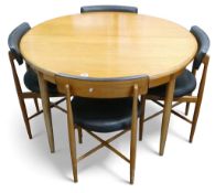 G-Plan Fresco round teak extending dining table with 4 black vinyl upholstered dining chairs.