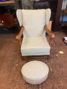 Pale green upholstered easy chair with hardwood frame and a matching footstool (2).