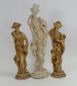 A pair of Chinese-style carved resin figures depicting a man and a woman in traditional dress with