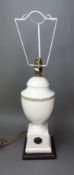 Wedgwood cream table lamp with gold accents and a basalt roundel to the front, raised on a