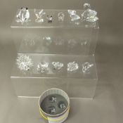 A collection of boxed Swarovski crystal animal figures, including Swan, frog, tortoise, panda,