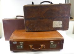 Three antique leather suit cases. (H: 20cm x L: 66cm x W: 43.5cm) (3)