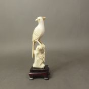 Chinese carved bone figure of a bird on a hardwood base, overall height 16cm.