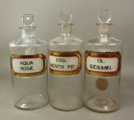 Three Antique Apothecary bottles with recessed labels reading OL: SESAMI, ESS: MENTH PIP and AQUA