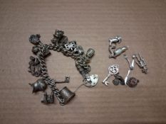 Sterling silver charm bracelet together with extra loose sterling silver charms, combined 117.2g.
