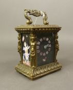 Brass carriage clock of small proportions with hand painted porcelain face and side panels, key