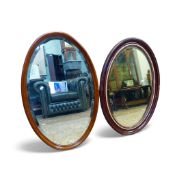 2x Oval wall mirrors with bevelled edge mirror. One with mahogany frame with carved details, the