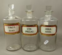 Three Antique Apothecary bottles with recessed labels reading VIN: IPECAC, TINCT: RHEI and AQUA