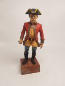 Hand painted lead figure of a pirate, crudely mounted to a wooden plinth, overall height 20cm.
