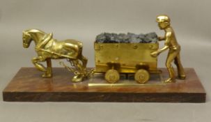 Brass Miner with Cart pulled by a Pit Pony on a wooden plinth together with a brass model of a Steam