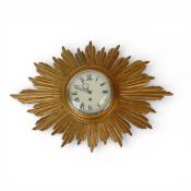 A vintage gilt sunburst wall clock. H39cm x W59cm.