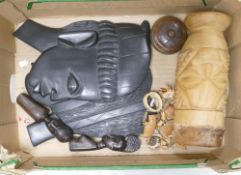 A collection of African wooden tribal items including pair face masks, carved wood drum, figures