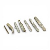 A collection of stainless steel and mother of pearl folding fruit knives, with intricate carvings or