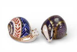 Royal Derby Paperweights to include:- Snail ceramic stopper together with Badger With gold