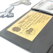 A large collection of military related items including cap badges, medals and paperwork, with