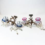 Two porcelain wall sconces, gilded metal scrolled arms depicting eagles with hanging crystal prisms.