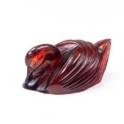 A Japanese Cherry Amber goose Netsuke, late 19th century, carved as a recumbent goose with tucked