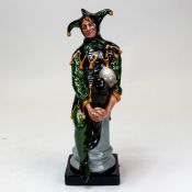 Royal Doulton prototype character figure of a Jester, painted in a green & black colourway on column