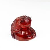 A Japanese Cherry Amber Cat Netsuke, late 19th century, carved as a curled cat, signed to base, L.