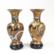 Pair of 19th century Japanese Satsuma vases, decorated with faces and dragon coiled around the body,