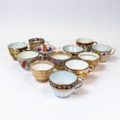 A collection of 19th century porcelain teacups in various patterns from different manufacturers