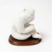 Chinese Hirado ware seated monkey, h.11.5cm, on wooden base.