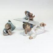 Lladró porcelain figurines compromising, How Sweet, no.6987, Angel Lying Down, no.4541, and Let's