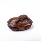 A Japanese wooden tortoise Netsuke, late 19th century - carved tortoise with baby tortoise on its