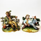 Two large Capodimonte figures of tramps on park benches, height of tallest 26cm (2).
