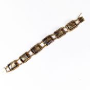 14ct gold Tennis bracelet set with six emerald cut Smokey Quartz stones, each stone approx. 1.25 x