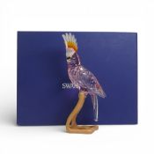 Swarovski Crystal Paradise Cockatoo Red figure mounted on wooden perch, designed by Roland Schuster,