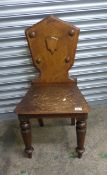 Mahogany and oak single shield back hall chair.