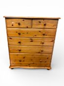 Pine tall boy, chest of 6 drawers in a 2 over 4 combination. On bun feet with drawers graduating -