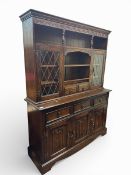 Vintage dark oak Jaycee linen fold dresser with leaded glass. Lower 3 doors/drawers with upper