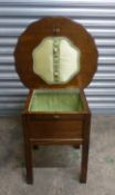 Morco oak sewing table/box raised on square supports, diameter of top 50cm, height 46cm.