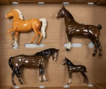 Four Beswick horse figures, to include a Palomino Prancing Arab, brown Hackney horse, small brown