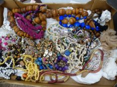 Large quantity of costume jewellery to include large wooden beads, beads and necklaces, gold
