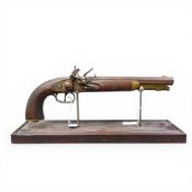 19th century flintlock pistol, presented on a purpose made display stand, length of pistol 40cm.