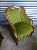 Early 20th century mahogany armchair with emerald green upholstery, raised on castors, width 65cm.