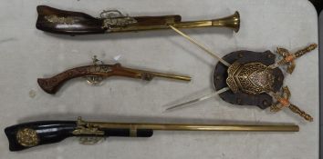 Three wall hanging display guns, together with a Spanish made shield and sword display piece (4).